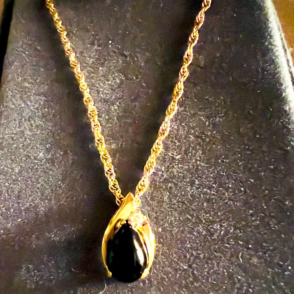 20” gold rope chain w/gold pendant has a black onyx look stone and small CZ